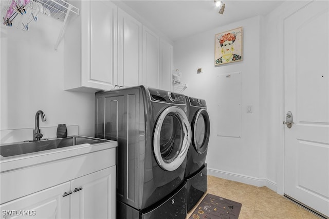 laundry area featuring washer and dryer, cabinets, light tile patterned floors, and sink