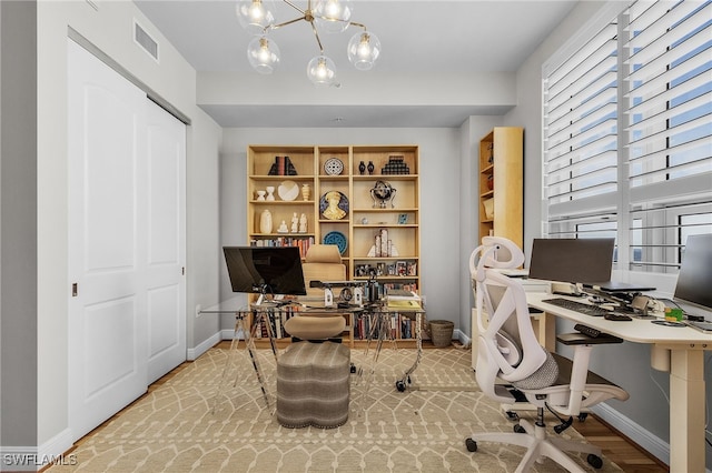 office space featuring light hardwood / wood-style floors and an inviting chandelier