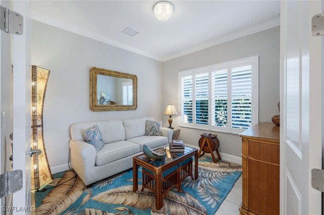 living room with baseboards, visible vents, and ornamental molding