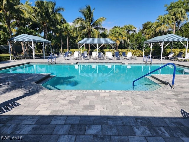 pool with a gazebo and a patio area