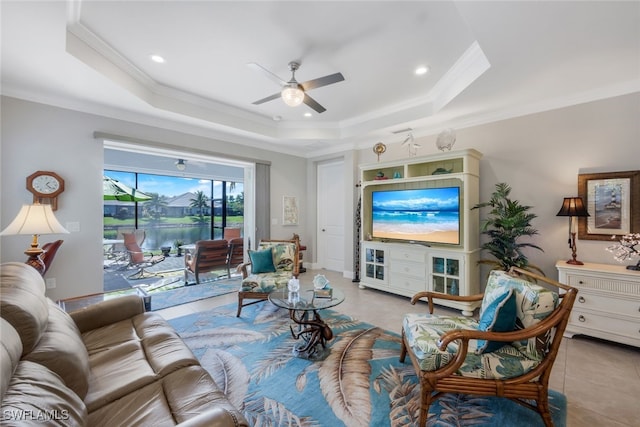 living room featuring light tile patterned flooring, a raised ceiling, and crown molding