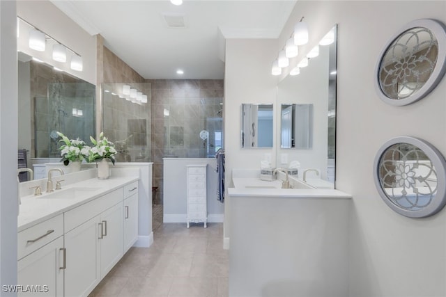 bathroom with tile patterned flooring, two vanities, walk in shower, and a sink