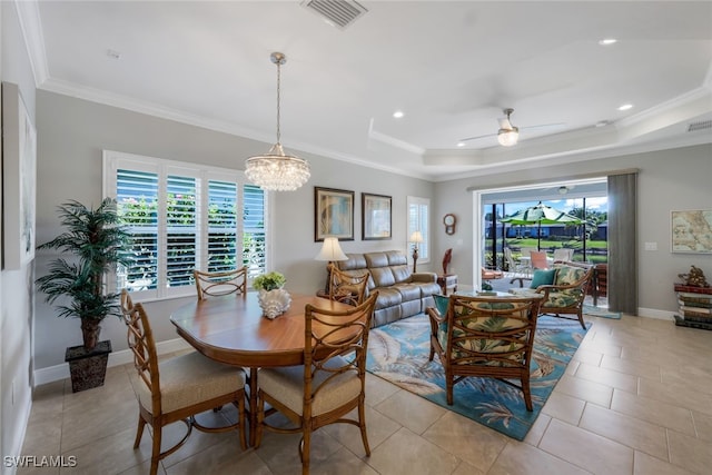 dining space with ornamental molding, a wealth of natural light, visible vents, and baseboards