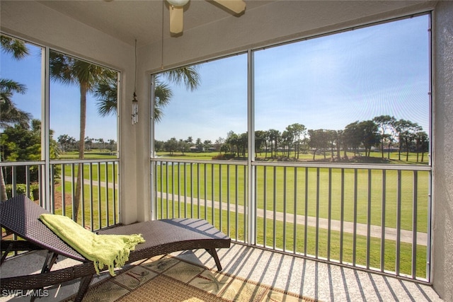 sunroom featuring ceiling fan