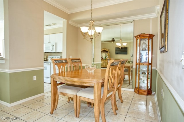 tiled dining area with ceiling fan with notable chandelier and ornamental molding