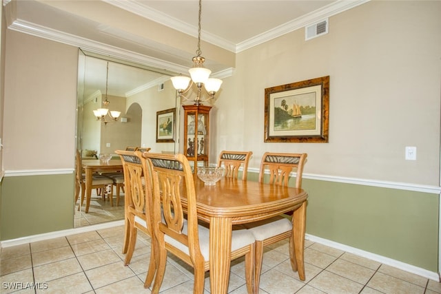 dining space featuring tile patterned floors, a chandelier, and ornamental molding