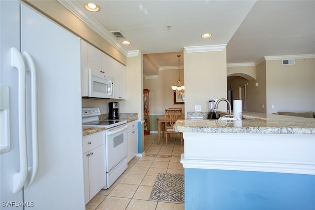 kitchen with white cabinets, light tile patterned floors, white appliances, and hanging light fixtures