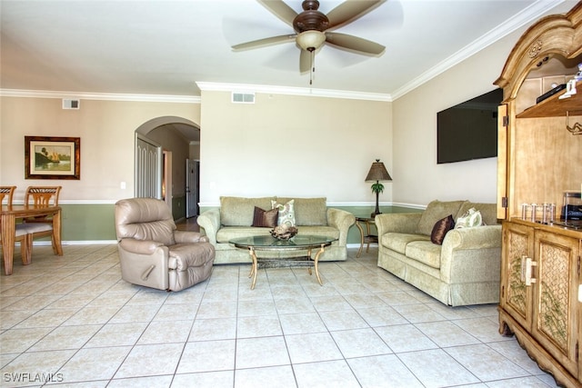 tiled living room with ceiling fan and crown molding