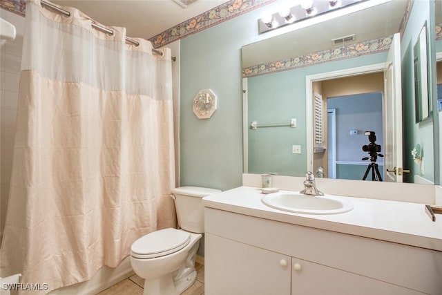 full bathroom featuring tile patterned flooring, shower / bath combo, vanity, and toilet