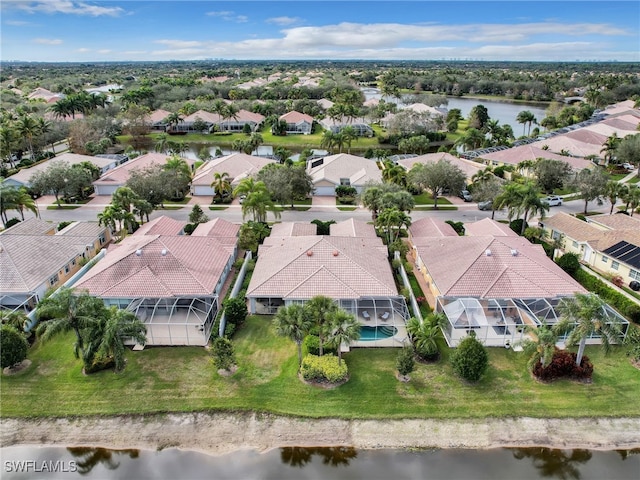 drone / aerial view with a residential view and a water view