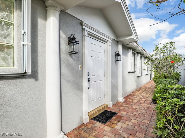 entrance to property with stucco siding