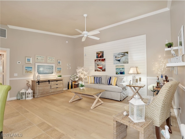 living room with baseboards, visible vents, a ceiling fan, ornamental molding, and wood finished floors