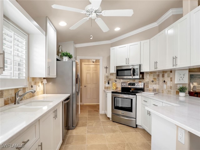 28265 Islet Trl, Bonita Springs, FL 34135 - kitchen with appliances with stainless steel finishes, a sink, white cabinetry, ornamental molding, and recessed lighting