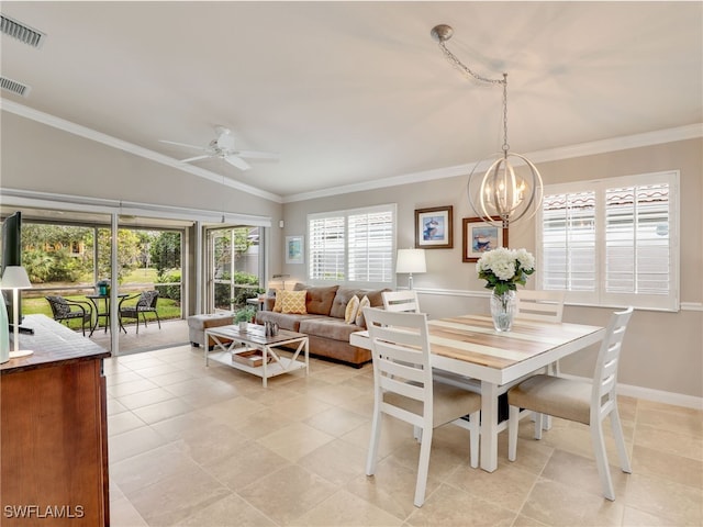 dining area with lofted ceiling, light tile patterned floors, ceiling fan with notable chandelier, visible vents, and crown molding