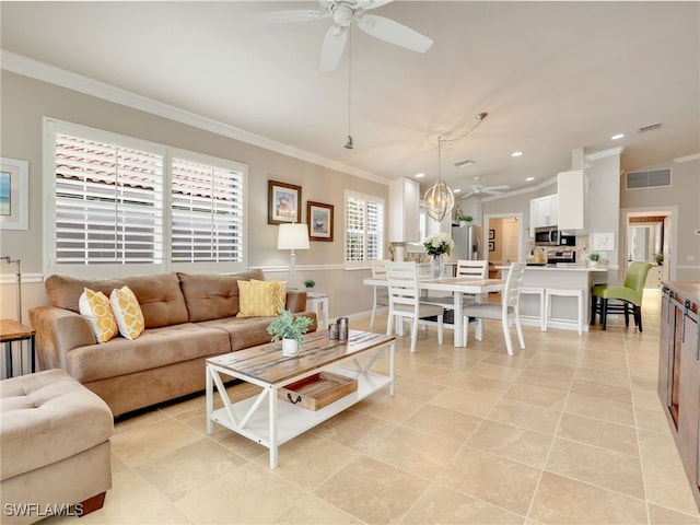 living area featuring ornamental molding, visible vents, and ceiling fan