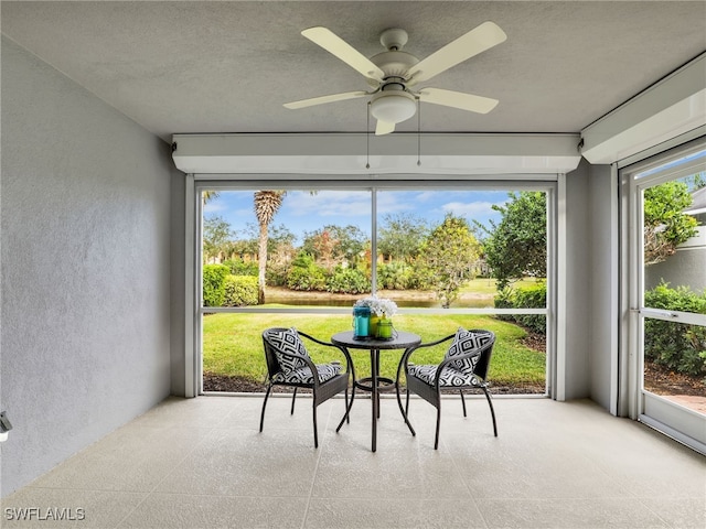 sunroom featuring a ceiling fan and a wealth of natural light