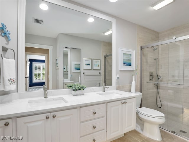 bathroom featuring a stall shower, visible vents, a sink, and toilet