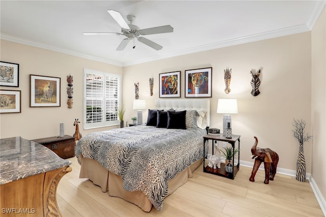 bedroom featuring light wood finished floors, ceiling fan, ornamental molding, and baseboards