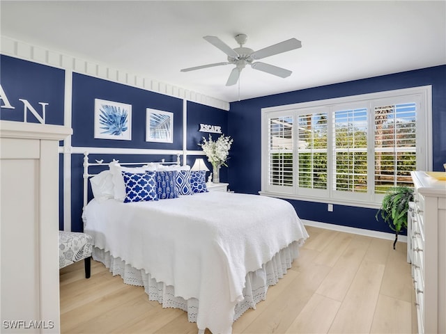 bedroom with baseboards, a ceiling fan, and wood finished floors