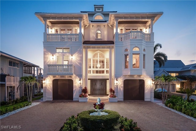 view of front of property with a balcony and a garage