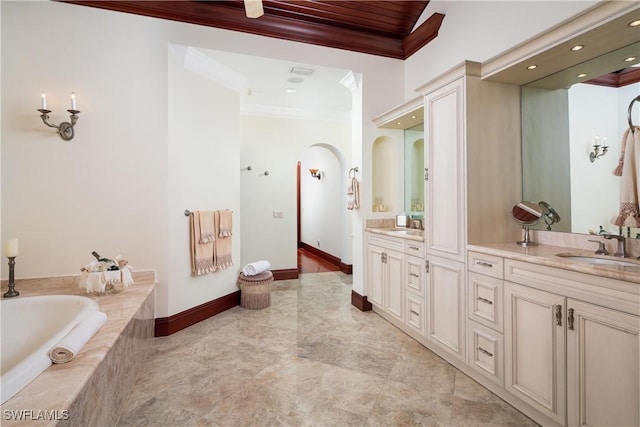 bathroom featuring a relaxing tiled tub, vanity, and crown molding