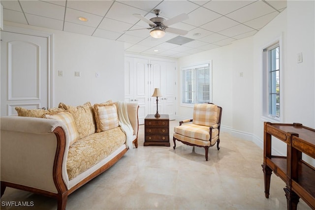 sitting room featuring ceiling fan and a paneled ceiling