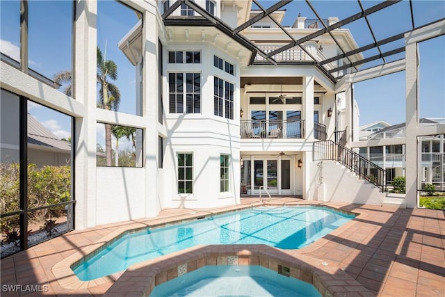 view of swimming pool with ceiling fan, a lanai, an in ground hot tub, and a patio area