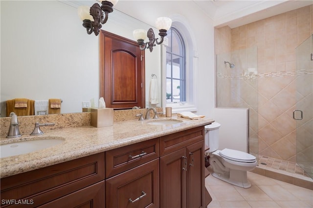 bathroom featuring toilet, vanity, tile patterned floors, and a shower with door