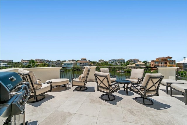 view of patio / terrace with a water view and grilling area