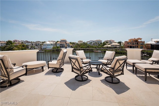 view of patio with a water view and a balcony