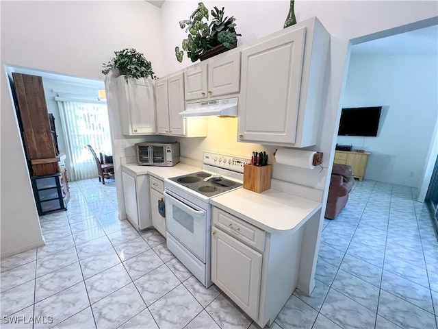 kitchen with electric range, white cabinets, and light tile patterned floors