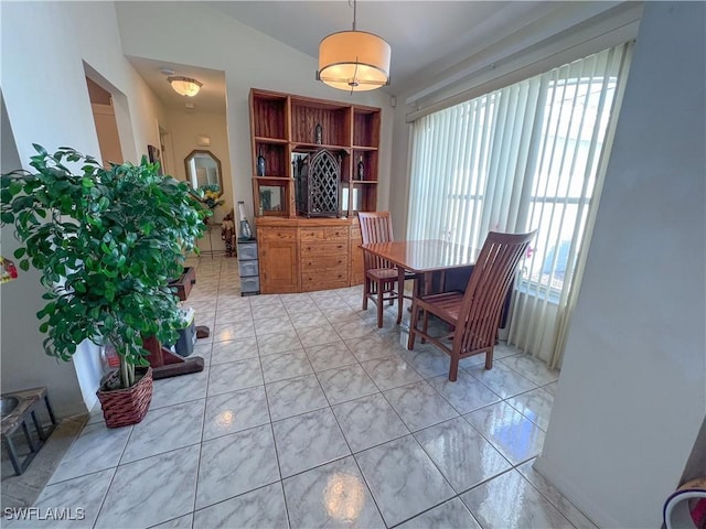 dining space featuring lofted ceiling