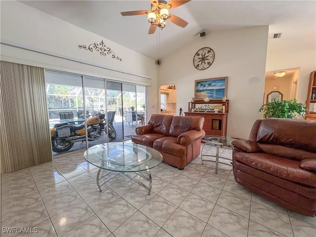 tiled living room featuring ceiling fan and high vaulted ceiling