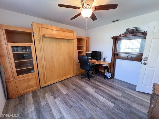 office with ceiling fan and dark wood-type flooring