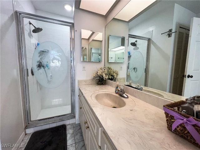 bathroom with tile patterned floors, vanity, and a shower with shower door