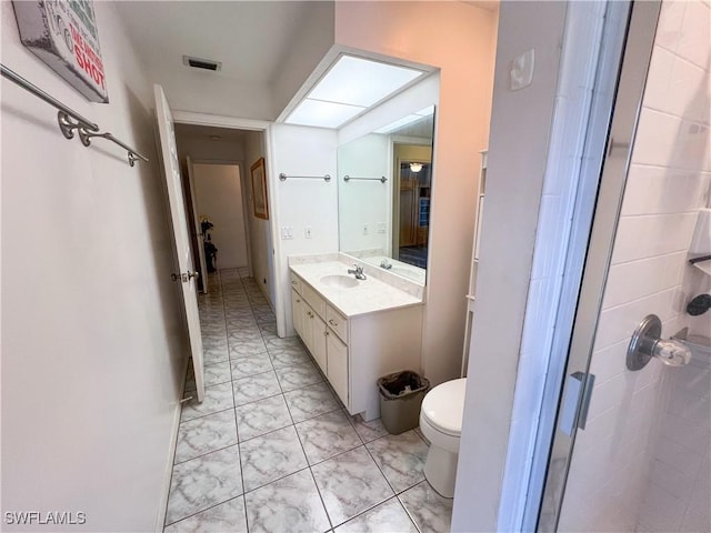 bathroom with vanity, an enclosed shower, and toilet