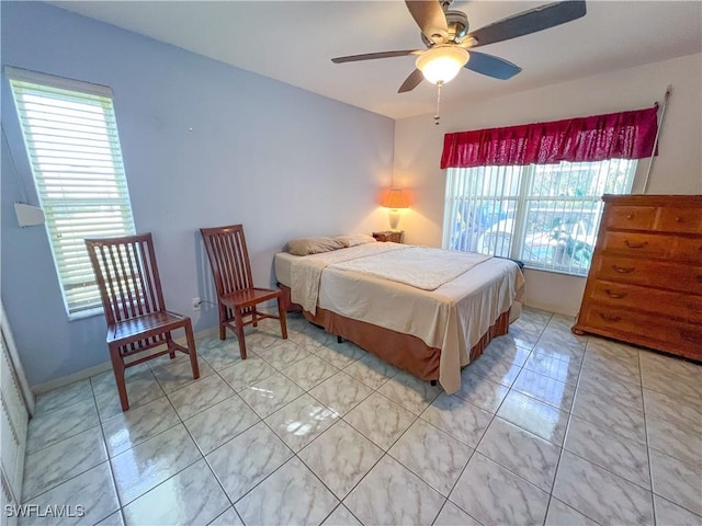 tiled bedroom featuring ceiling fan