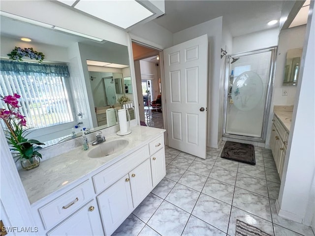 bathroom with vanity and a shower with door