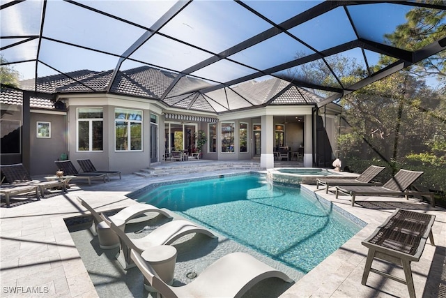 view of pool with a patio, a lanai, and a pool with connected hot tub