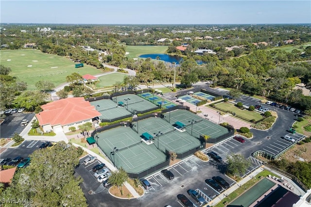 aerial view with golf course view and a water view