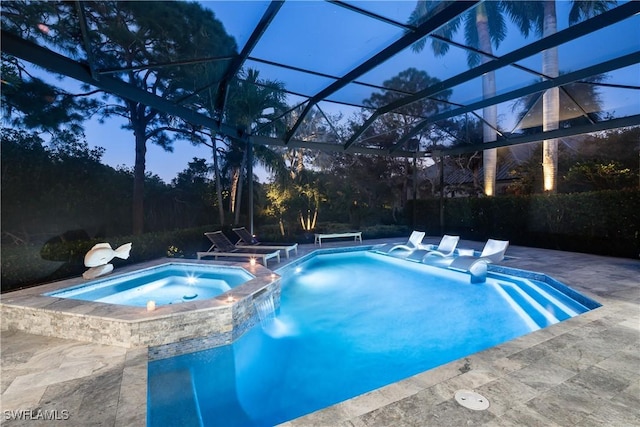 view of pool with a pool with connected hot tub, a lanai, and a patio area