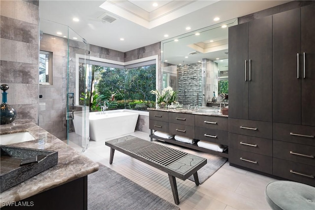 full bath featuring plenty of natural light, a stall shower, tile walls, and vanity