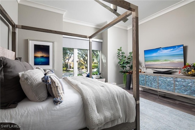 bedroom featuring wood finished floors and crown molding