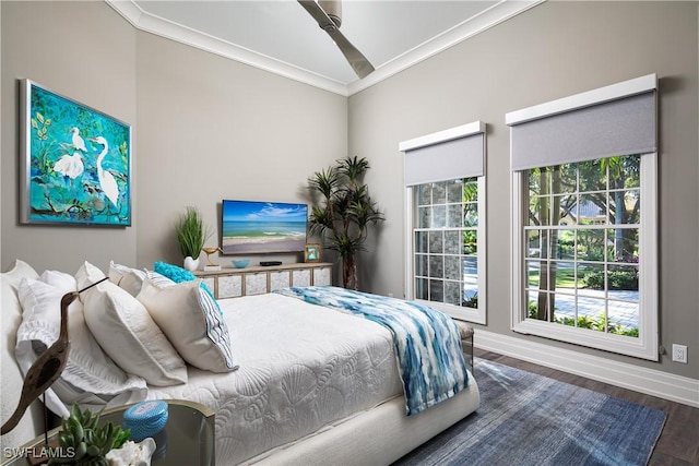 bedroom featuring ceiling fan, wood finished floors, baseboards, and ornamental molding