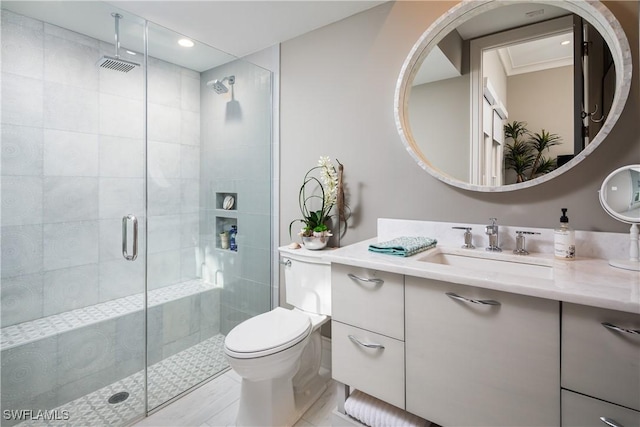 bathroom featuring a shower stall, vanity, and toilet