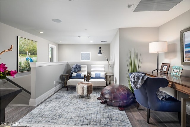 living area featuring visible vents, baseboards, an upstairs landing, recessed lighting, and wood finished floors