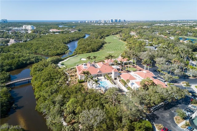 birds eye view of property with view of golf course and a water view