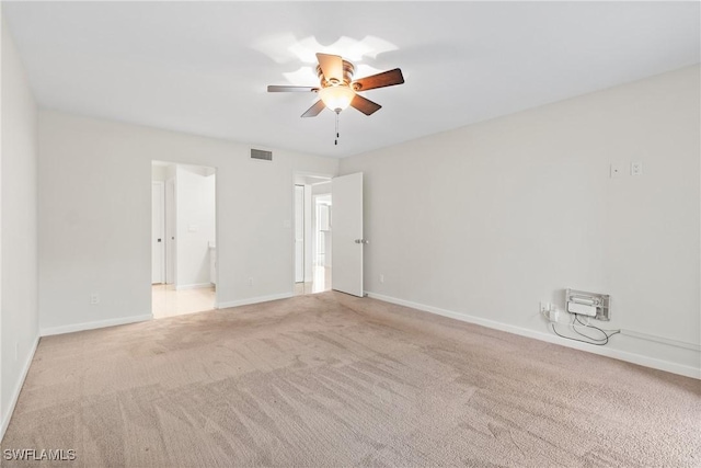 carpeted spare room with ceiling fan