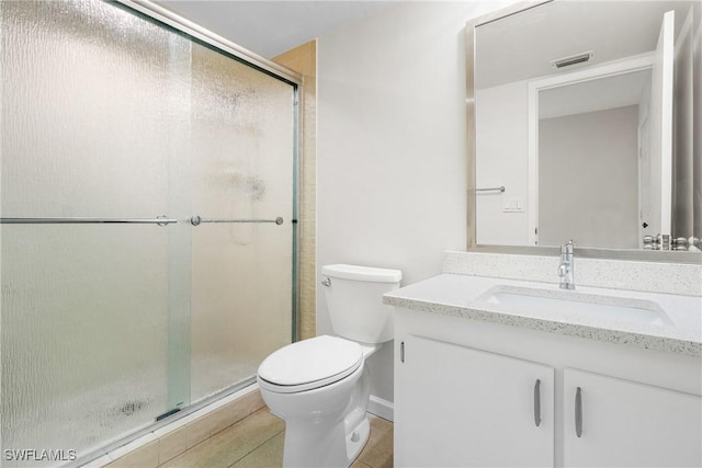 bathroom with vanity, toilet, and an enclosed shower