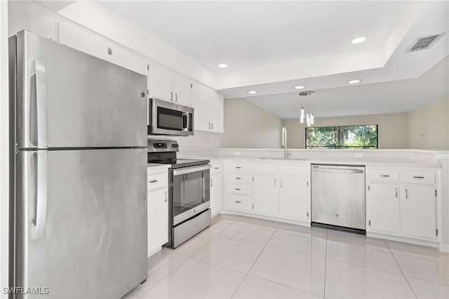 kitchen featuring decorative light fixtures, stainless steel appliances, white cabinetry, and sink